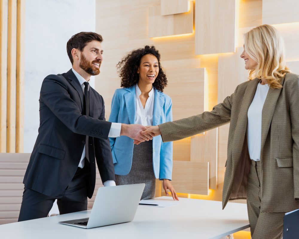 group-of-multiethnic-businesspeople-shaking-hands-for-a-business-deal.jpg